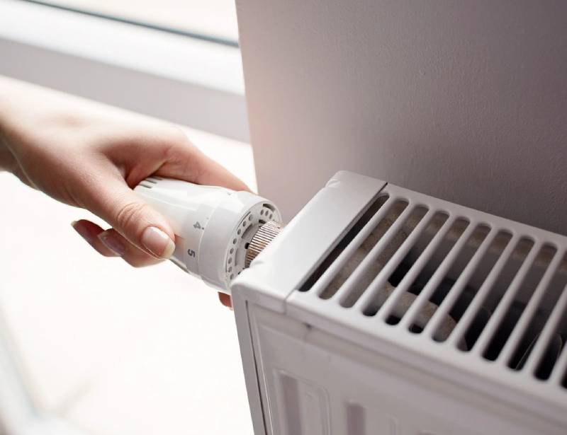 A person is using an air conditioner to cool it.