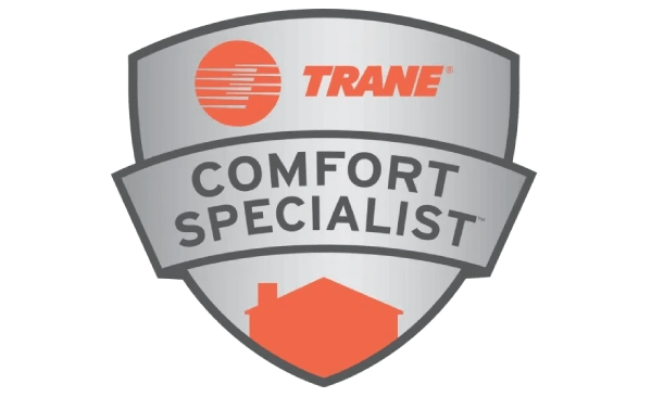 A trane comfort specialist badge with a house in the background.