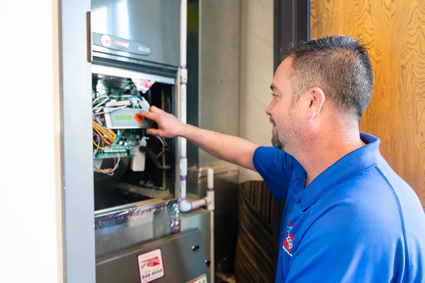 A man is working on an oven